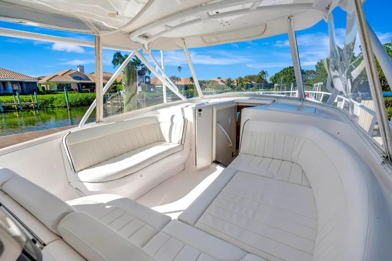 Yacht Photos Pics Luxurious 2012 Intrepid 400 Cuddy boat interior with white seating and scenic waterfront view.