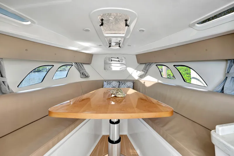  Yacht Photos Pics Interior of 2012 Intrepid 400 Cuddy boat with sleek seating and wooden table.