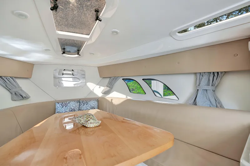  Yacht Photos Pics Interior of 2012 Intrepid 400 Cuddy with cozy seating and wooden table.