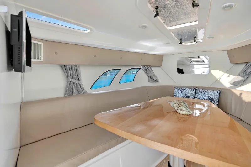  Yacht Photos Pics Interior of 2012 Intrepid 400 Cuddy boat with elegant seating and wooden table.