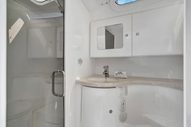  Yacht Photos Pics Luxurious bathroom interior of 2012 Intrepid 400 Cuddy yacht, featuring sleek white design.