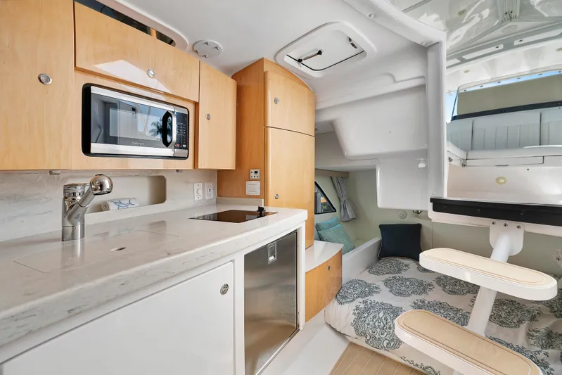  Yacht Photos Pics 2012 Intrepid 400 Cuddy interior with kitchenette, microwave, and cozy sleeping area.