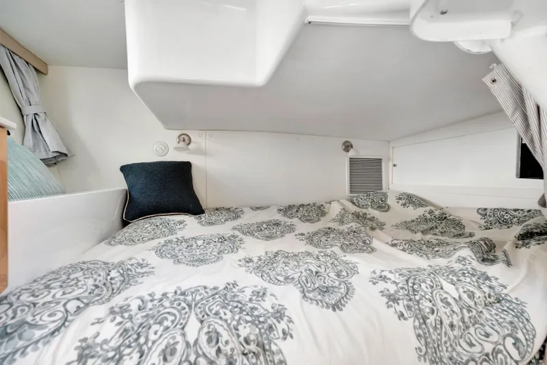  Yacht Photos Pics Cozy cabin interior of 2012 Intrepid 400 Cuddy with patterned bedding and pillow.