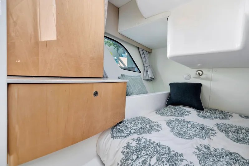  Yacht Photos Pics Cozy cabin interior of 2012 Intrepid 400 Cuddy with wood cabinets and patterned bedding.