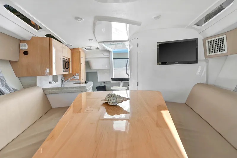  Yacht Photos Pics Interior of 2012 Intrepid 400 Cuddy boat with modern kitchen and seating area.