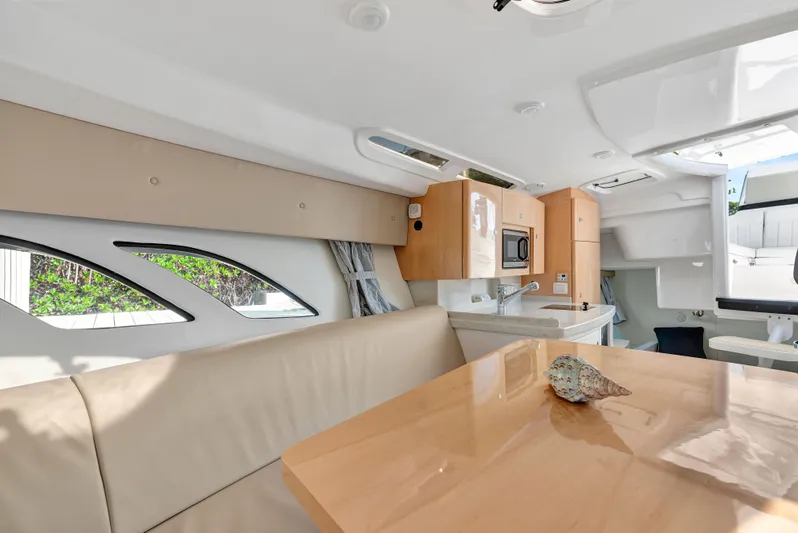  Yacht Photos Pics Interior of 2012 Intrepid 400 Cuddy boat with modern kitchen and seating area.