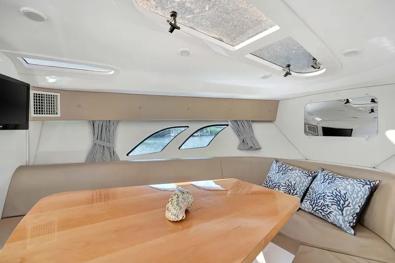  Yacht Photos Pics Interior of 2012 Intrepid 400 Cuddy with elegant seating and wooden table.