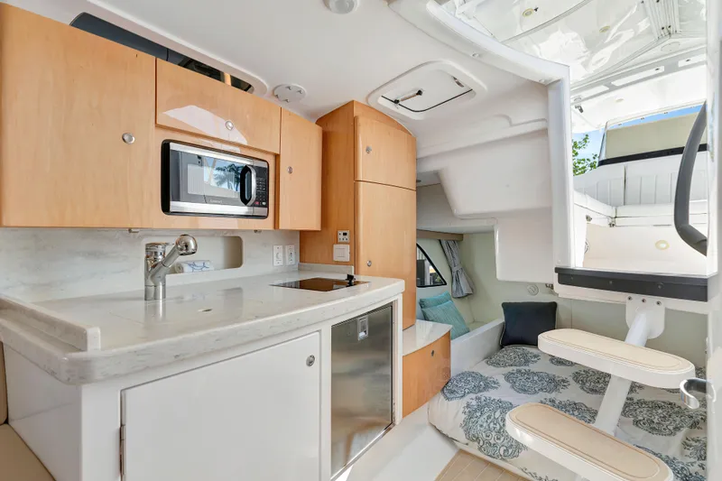  Yacht Photos Pics Interior of 2012 Intrepid 400 Cuddy boat with kitchenette and seating area.