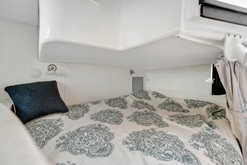  Yacht Photos Pics Cozy cabin interior of 2012 Intrepid 400 Cuddy with patterned bedding and pillow.