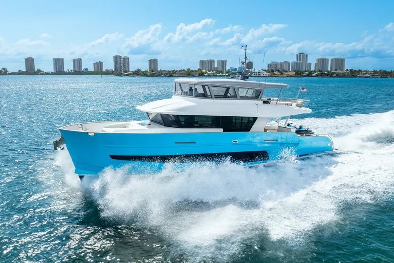 Lady Sadie Yacht Photos Pics Van der Valk LeVen 90 yacht cruising on ocean, city skyline in background, 2019 model.