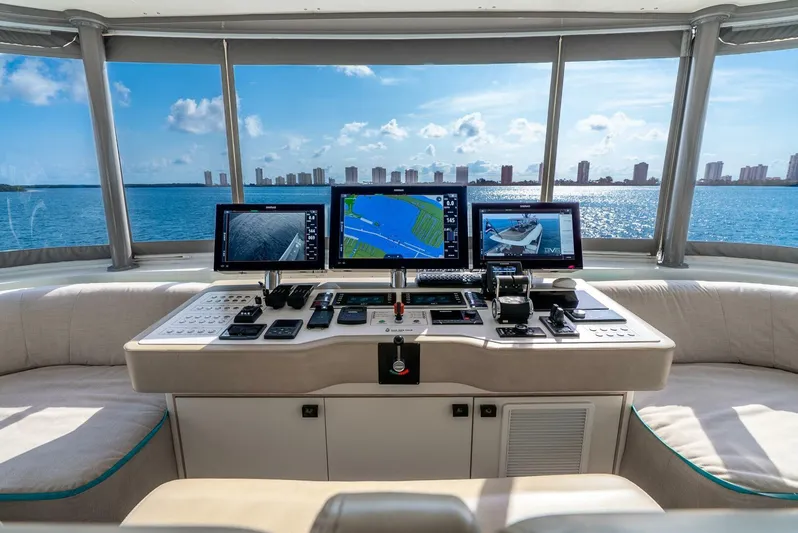 Lady Sadie Yacht Photos Pics Helm of 2019 Van der Valk LeVen 90 yacht with navigation screens, overlooking ocean and skyline.