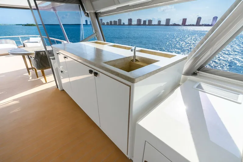 Lady Sadie Yacht Photos Pics Luxurious Van der Valk LeVen 90 yacht deck with modern kitchenette, ocean view, and city skyline.