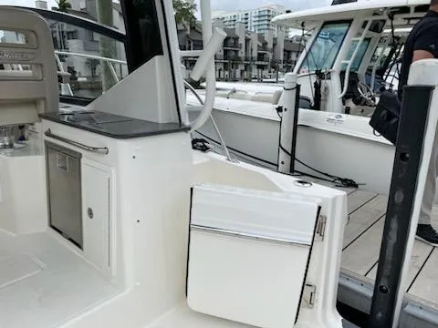  Yacht Photos Pics 2023 Boston Whaler 325 Conquest interior with kitchenette and dock view.