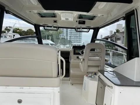  Yacht Photos Pics Interior view of 2023 Boston Whaler 325 Conquest boat, featuring helm and seating area.
