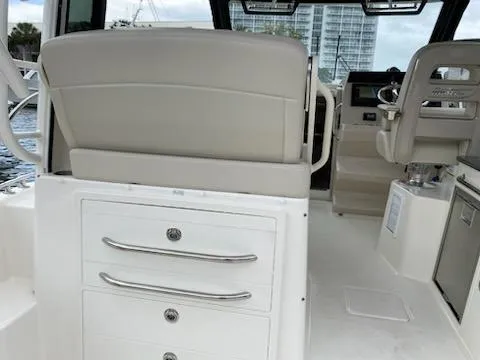  Yacht Photos Pics Interior of 2023 Boston Whaler 325 Conquest boat, featuring seating and storage drawers.