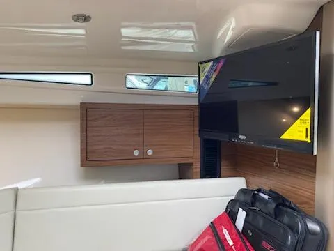  Yacht Photos Pics Interior of 2023 Boston Whaler 325 Conquest with TV and storage cabinets.