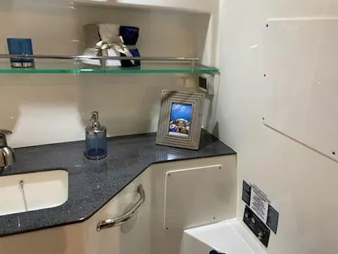  Yacht Photos Pics Interior of 2023 Boston Whaler 325 Conquest, featuring a modern bathroom with sleek countertop.