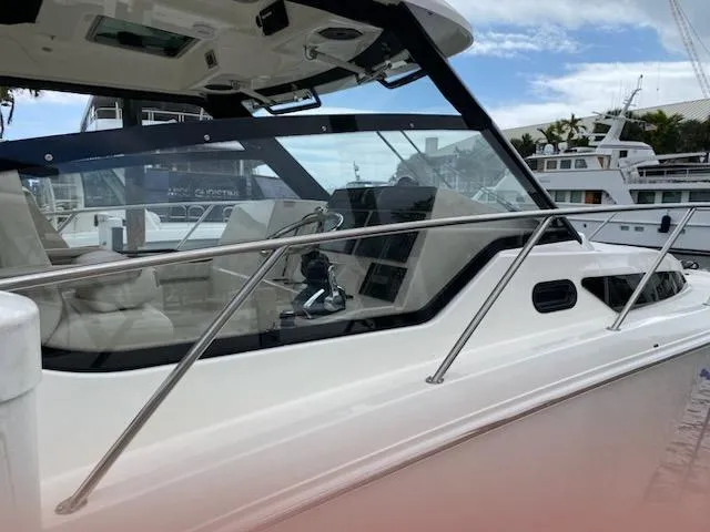  Yacht Photos Pics 2023 Boston Whaler 325 Conquest boat, sleek design, docked at marina.