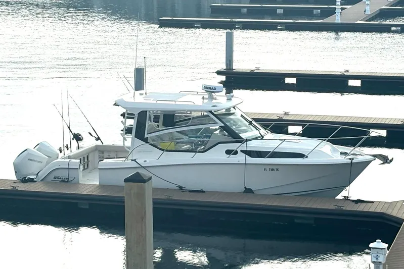  Yacht Photos Pics 2023 Boston Whaler 325 Conquest docked at marina, side view.