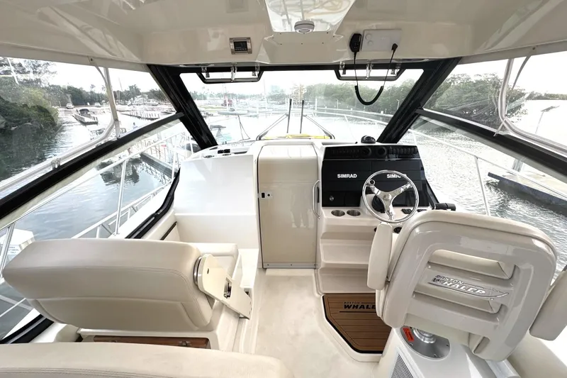  Yacht Photos Pics 2023 Boston Whaler 325 Conquest helm with modern controls and panoramic view.