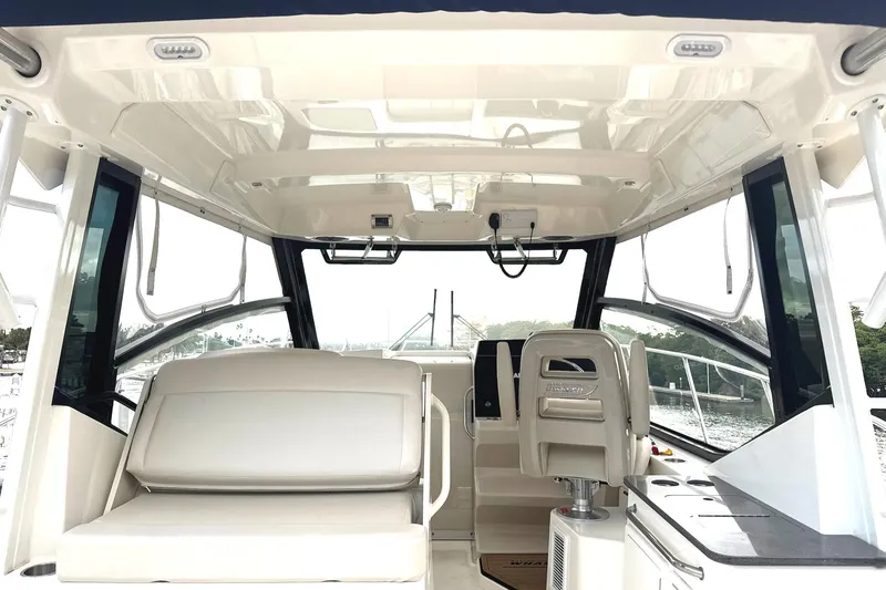  Yacht Photos Pics Interior of 2023 Boston Whaler 325 Conquest boat, featuring seating and helm area.