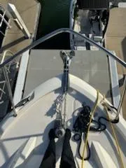  Yacht Photos Pics Bow view of 2023 Boston Whaler 325 Conquest at dock with ropes and anchor.