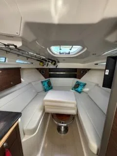  Yacht Photos Pics 2023 Boston Whaler 325 Conquest cabin interior with white seating and skylight.