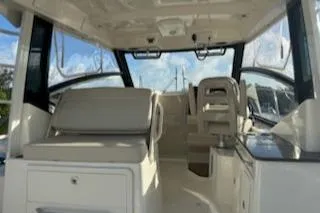  Yacht Photos Pics Interior of 2023 Boston Whaler 325 Conquest boat with seating and helm.