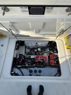  Yacht Photos Pics 2023 Boston Whaler 325 Conquest engine compartment with open hatch, showcasing internal components.