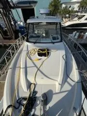  Yacht Photos Pics 2023 Boston Whaler 325 Conquest boat docked with ropes on deck.