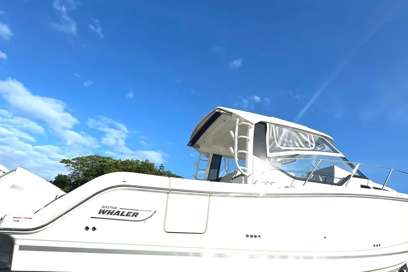  Yacht Photos Pics 2023 Boston Whaler 325 Conquest boat under clear blue sky.