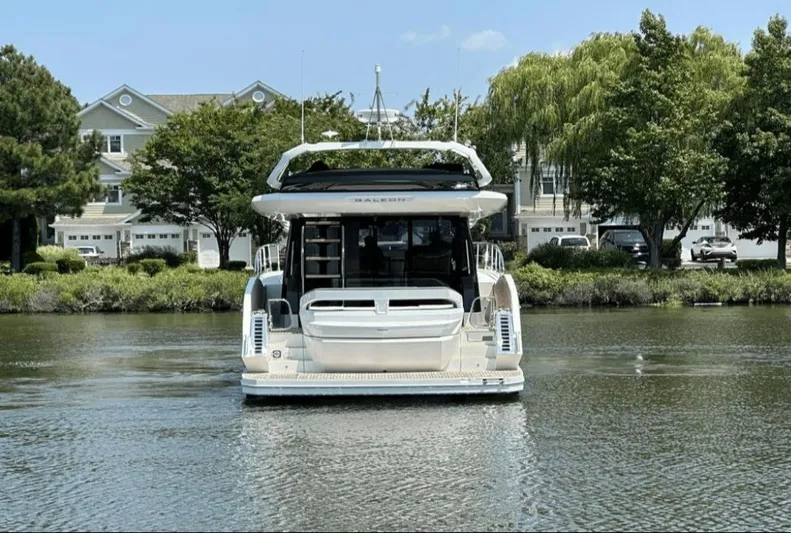 The Good Life Yacht Photos Pics 2024 Galeon 510 Sky yacht on calm water near houses.