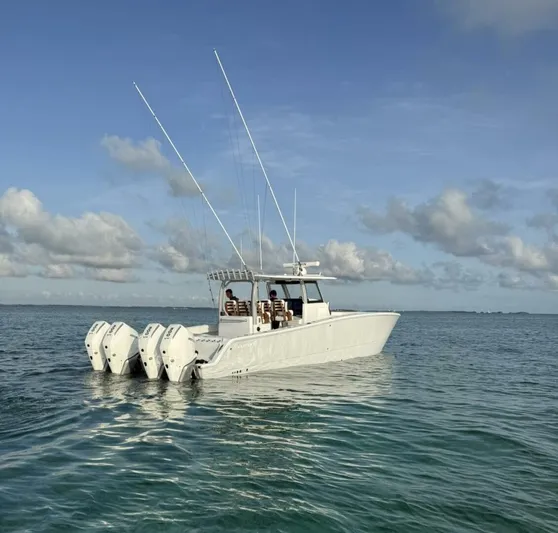  Yacht Photos Pics 2026 Freeman 38 boat with multiple engines on calm ocean waters.