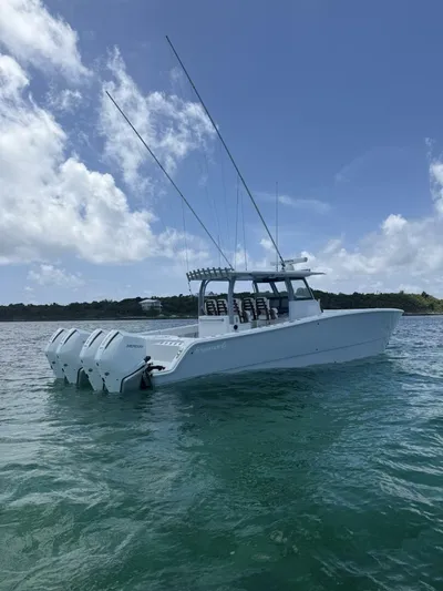  Yacht Photos Pics 2026 Freeman 38 boat with multiple outboard engines on calm water under blue sky.