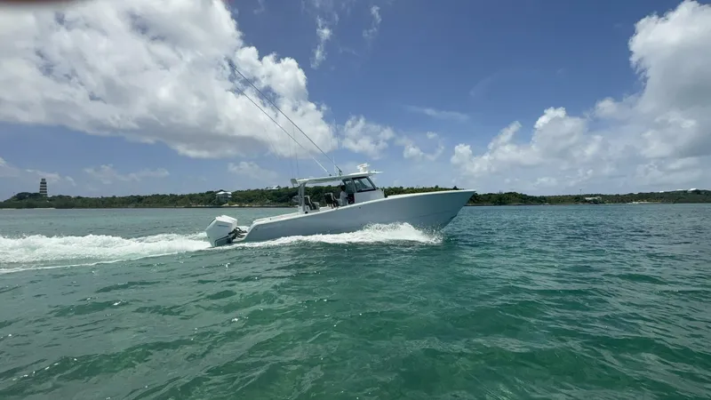  Yacht Photos Pics 2026 Freeman 38 boat cruising on clear blue water under a partly cloudy sky.