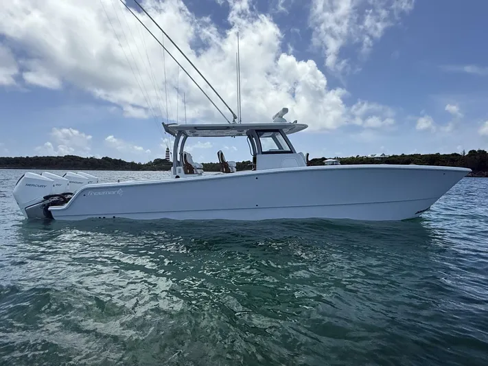  Yacht Photos Pics 2026 Freeman 38 boat on water under blue sky with clouds.