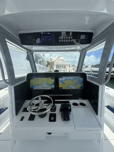  Yacht Photos Pics Modern Freeman 38 boat cockpit with dual navigation screens, steering wheel, and controls, 2026 model.