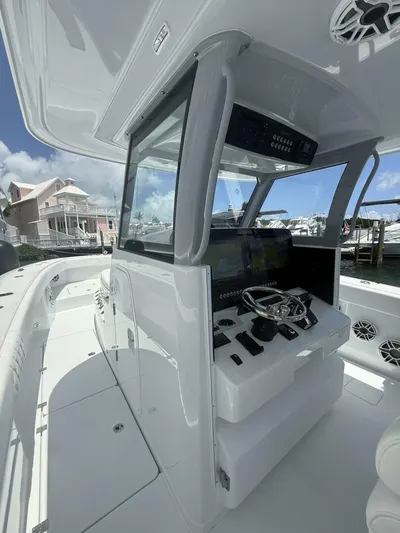  Yacht Photos Pics Modern Freeman 38 boat cockpit with advanced controls, docked near waterfront homes, 2026 model.