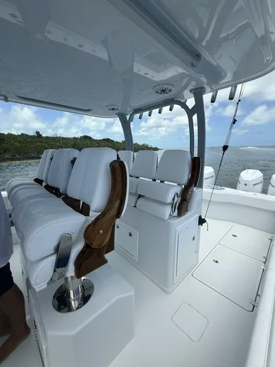  Yacht Photos Pics Luxurious seating on a 2026 Freeman 38 boat, featuring white cushions and wooden accents.
