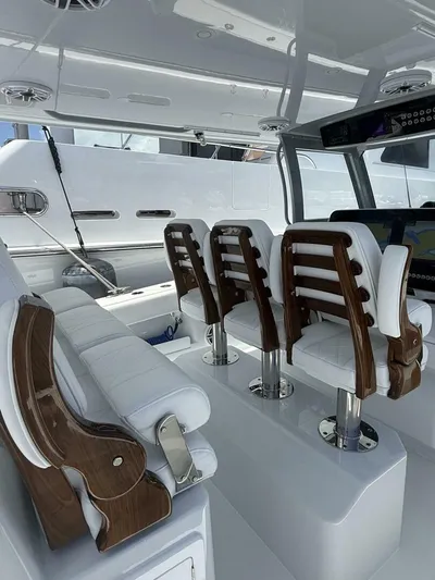  Yacht Photos Pics Luxurious interior of 2026 Freeman 38 boat with elegant white seating and wood accents.