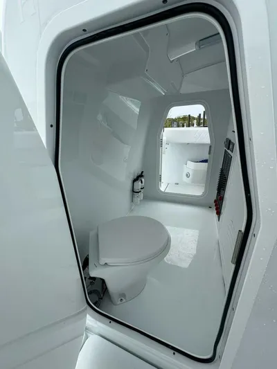  Yacht Photos Pics Interior view of Freeman 38 boat bathroom, featuring a modern toilet and sleek design, 2026 model.