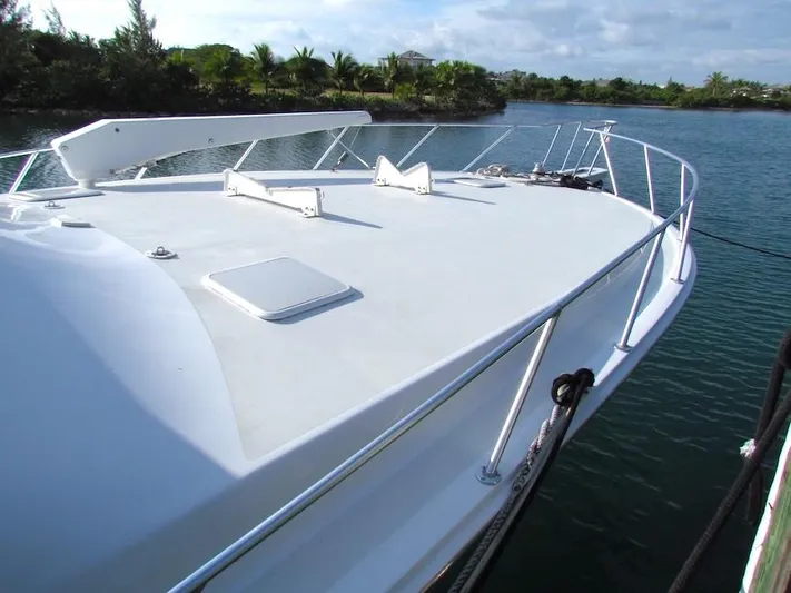  Yacht Photos Pics 1999 Viking Boats Convertible yacht docked on a serene waterway.