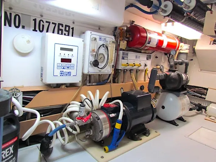  Yacht Photos Pics Engine room of 1999 Viking Boats Convertible with equipment and wiring.