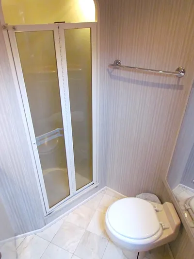 Yacht Photos Pics 1999 Viking Boats Convertible bathroom with shower, toilet, and towel rack.