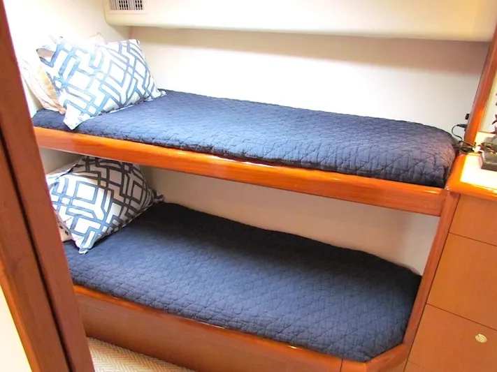  Yacht Photos Pics Bunk beds with blue bedding in a 1999 Viking Convertible boat cabin.