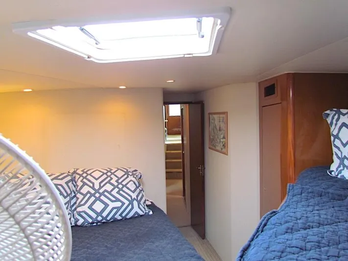  Yacht Photos Pics Interior cabin of 1999 Viking Boats Convertible with cozy bedding and natural light.