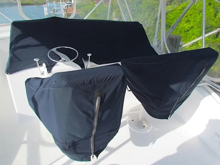  Yacht Photos Pics 1999 Viking Boats Convertible helm covered with protective fabric on a sunny day.