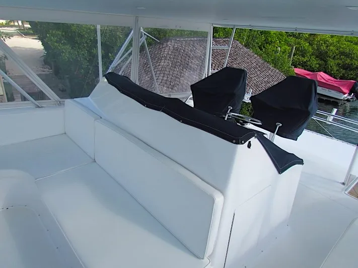  Yacht Photos Pics 1999 Viking Boats Convertible interior with white seating and covered controls.