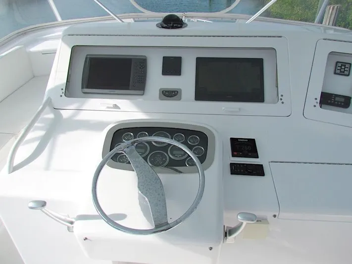  Yacht Photos Pics 1999 Viking Boats Convertible helm with steering wheel and navigation controls.