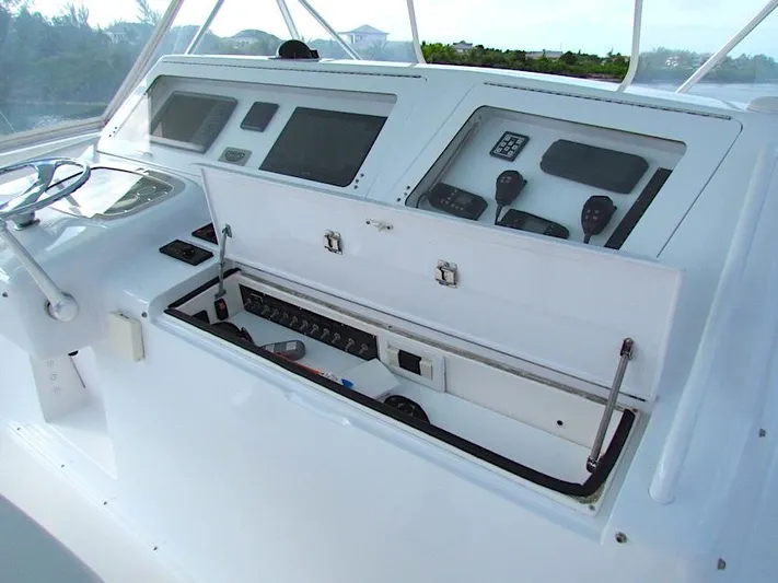  Yacht Photos Pics 1999 Viking Boats Convertible helm with open control panel, featuring navigation instruments and controls.